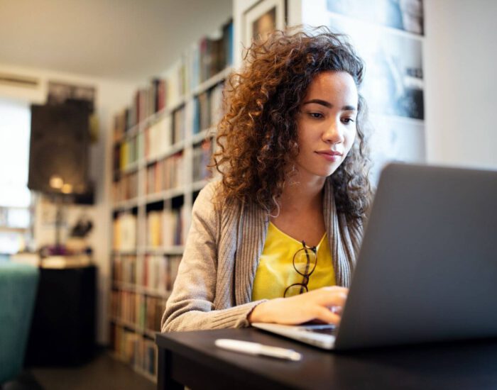 Young woman typing on a laptop
